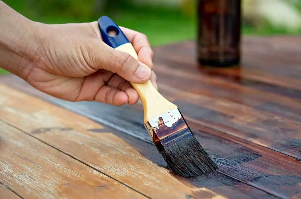 brush staining a wood deck